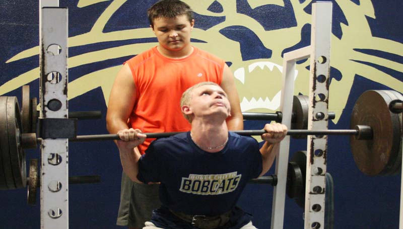 DAILY LEADER / MARTY ALBRIGHT / Bogue Chitto's Brandon McKenzie (front) does some heavy squats in the last day of summer workouts as his teammate Hayden Burton stands behind him as a spotter. The Bobcats will visit Loyd Star for the Possum Bowl, Aug. 22.