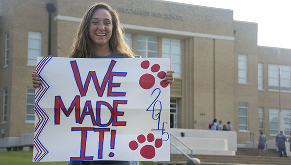 DAILY LEADER / KATIE WILLIAMSON / Senior Madie Currie holds up her sign in front of Brookhaven High School on the first day of school early Thursday.