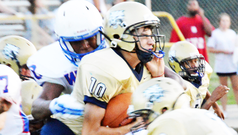 DAILY LEADER /T RACY FISCHER / Bogue Chitto quarterback Tucker Lambert (10) is stopped by Wesson's Jermaine James (7)and Kendrick Brown (20) during Friday's jamboree.