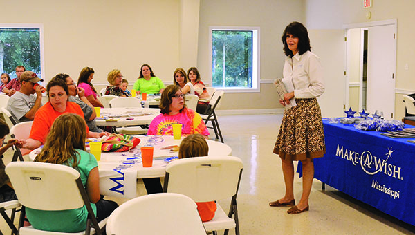 DAILY LEADER / RACHEL EIDE / During the program, Jane Walsh, Make-A-Wish Mississippi development manager, passed out packets and gave a brief overview of the program.