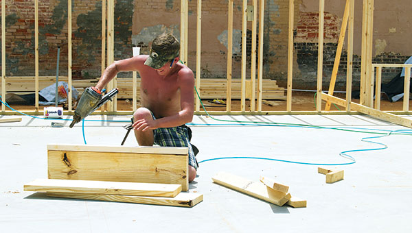 DAILY LEADER / RACHEL EIDE / Meanwhile, Martin Lindsey, also with DWD, works on another part of the project. DWD is in charge of the framing portion of the building, and work was moving quickly with all four wall frames up by Thursday morning.