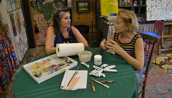 DAILY LEADER / RACHEL EIDE / Ava Jane Newell (from left) and Sue Minter talk Wednesday afternoon in The Art Barn about plans for painting workshops planned for Oct. 24-25. All paints and media will be provided to registered participants, and artists need only bring a few personal supplies such as the items displayed on the table. The workshops are jointly sponsored by The Art Barn and Brookhaven Regional Arts Guild.