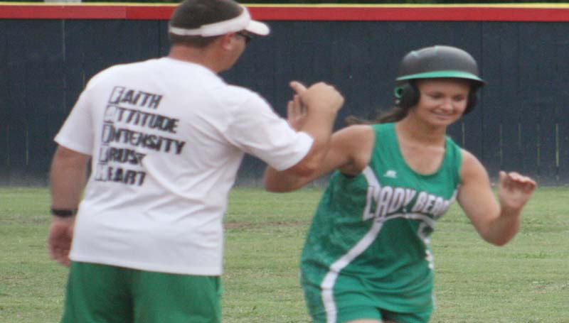 DAILY LEADER / MARTY ALBRIGHT / West Lincoln's MaKennah Redd (right) receives a high five from her coach Andrew Redd after hitting a two-run and a three-run home run Monday night against Brookhaven.