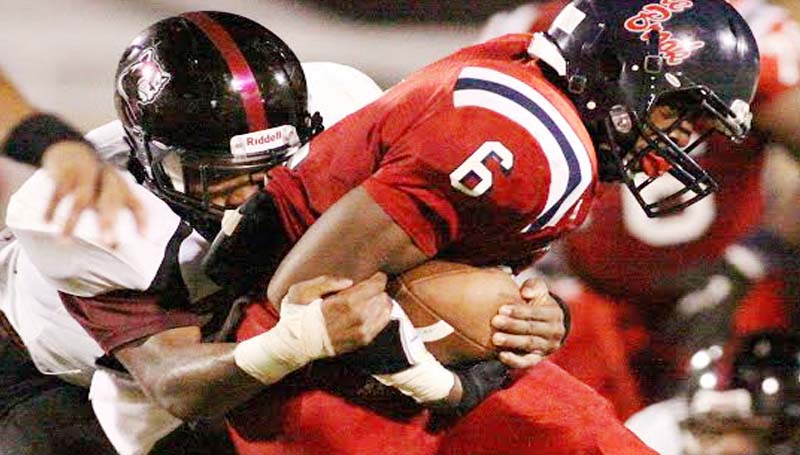 DAILY LEADER / JONATHON ALFORD / Brookhaven running back Tre McDaniel (6) holds on to the ball as Lawrence County defender T-Tex Cole bring him down.