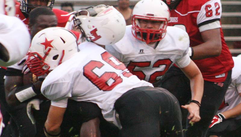 DAILY LEADER / MARTY ALBRIGHT / Loyd Star defensive linebacker Peyton Flowers (69) provides a crushing hit on a Prentiss running back Friday night at A.E. Gray Field.