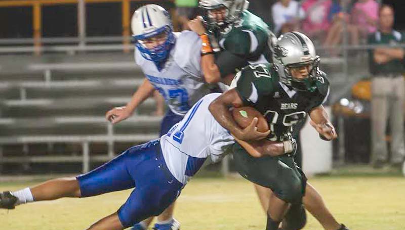 DAILY LEADER / TERESA ALLRED / West Lincoln running back Jade Use (17) eludes a Sacred Heart tackler to gain some big yards Friday Night at Perry Miller Field.