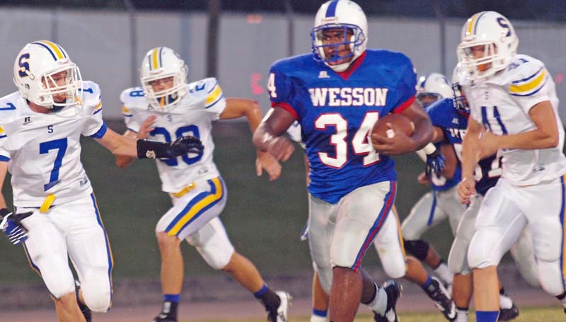 DAILY LEADER / TRACY FISCHER / Wesson's Arthur Harris (34) outruns Sumrall defenders Rhett Harvey (7), Jacob Phelps (28) and Grant Baxter (41) for a huge gain Friday night at Stone Stadium.