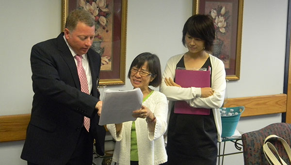 PHOTO SUBMITTED / William Gates, director of the Mississippi Adolescent Center in Brookhaven, (from left) discusses the services provided by the center with Yukari Ogita, member of the Osaka Prefectural Assembly, Health and Welfare Committee, of Japan, as her translator looks on. The Japanese visitors toured the local center earlier this month.