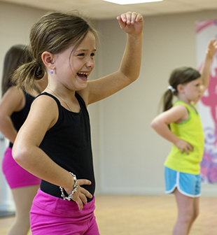 DAILY LEADER / KATIE WILLIAMSON / Bryleigh Garner, 7, can't help but giggle a bit while learning dance moves in the Brookhaven Dance Academy ballet class Wednesday at the Brookhaven Recreation Center.
