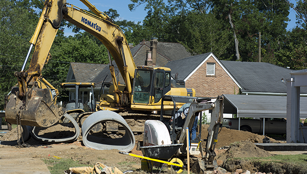 DAILY LEADER / KATIE WILLIAMSON / Work crews take over an area on West Chickasaw Street to replace drainage culverts Thursday. The project began two weeks ago and will most likely continue a few more weeks, according to Steve Moreton, director of public works for the city of Brookhaven. Workers will be inserting culverts and pouring concrete over bricks in the drainage tunnel across the street. Moreton said there are no other similar projects planned.