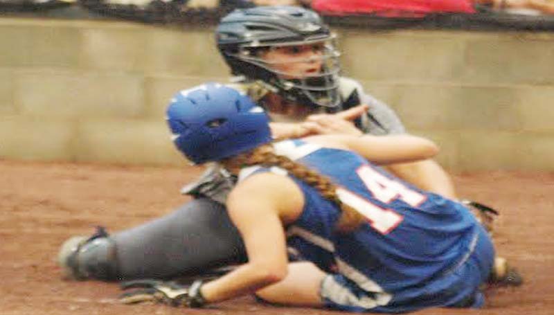 DAILY LEADER / TRACY FISCHER / Bogue Chitto catcher Reagan Kirkland (15) tags out Wesson's Kayla Britt (14) sliding into home plate Thursday night.