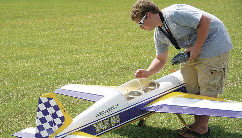 DAILY LEADER / KATIE WILLIAMSON / Casey Koehler, 15, of Summit turns off his Yak 54 airplane after its flight Saturday.