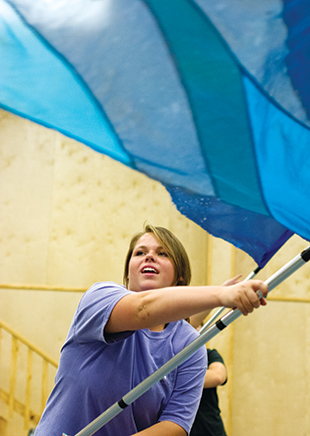 DAILY LEADER / KATIE WILLIAMSON / Kerri Newell, 16, twirls her flag during Loyd Star color guard practice Tuesday.
