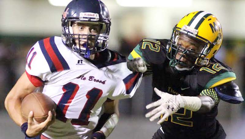 DAILY LEADER / JONATHON ALFORD / Brookhaven's Jon-Mark Mathis (11) escapes McComb's defender Rashad Boddie (12) to gain a first down Friday night.