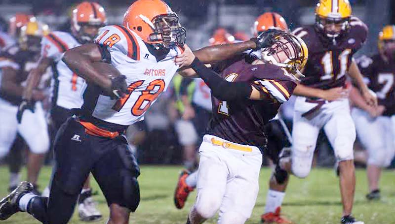 DAILY LEADER / THERESA ALLRED / Leake County's Tobias Edwards (18) grabs the face mask of Enterprise's defender Trestin Cantrell (1) to gain some big yardage in Friday night action at Harry Cole Field. The Gators beat the Jackets 58-8. Further information was not provided before press time. Check Tuesday paper for local coverage.