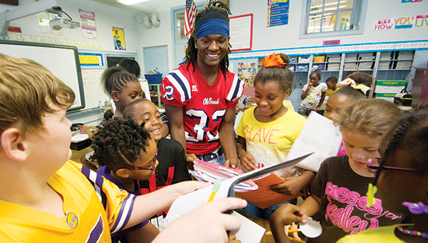 DAILY LEADER/ KATIE WILLIAMSON / Ken Boyd signs autographs for Brookhaven Elementary School teacher Samantha Rushing's third-grade class during the read like a champion event Friday.