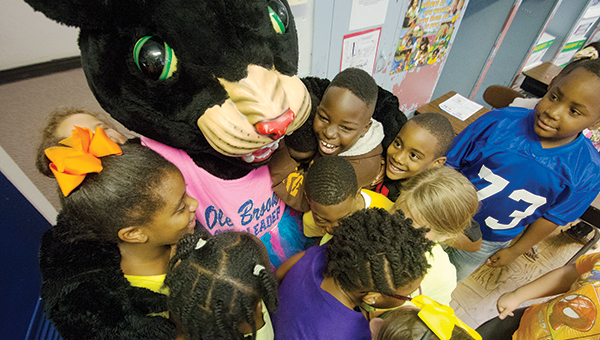 DAILY LEADER / KATIE WILLIAMSON / Polly the Panther gets hugged by Brookhaven Elementary School teacher Samantha Rushing's third-grade class during the read like a champion event Friday.