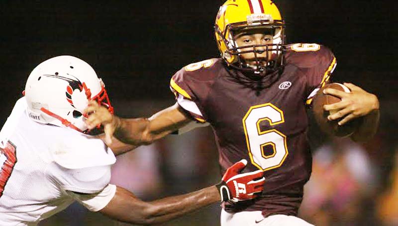 DAILY LEADER / JONATHON ALFORD / Enterprise runningback Chance Lacking (6) pushes off Loyd Star's tackler Patrick Price (9) with a stiff arm for a big gain Friday night at Harry Cole Field.