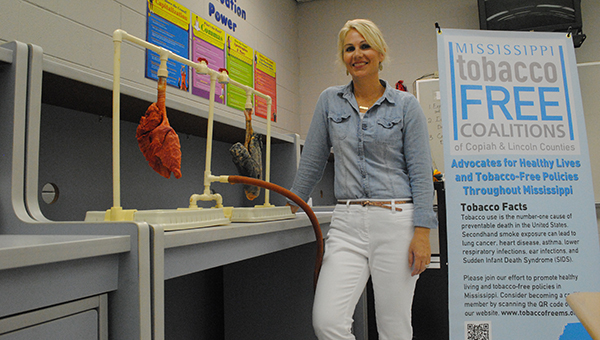 Lori Carter demonstrates the difference between a healthy lung and a smoker's lung in Maria Knight's family dynamics class at the Brookhaven Technical Center