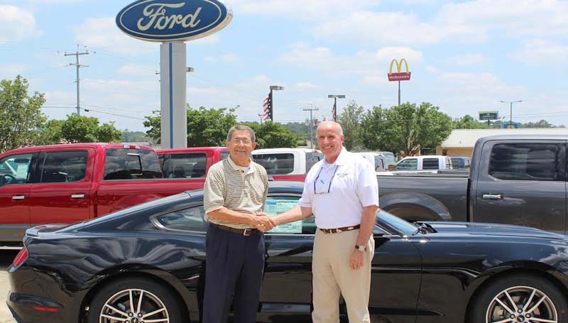 CO-LIN MEDIA / Photo Submitted / HOLE IN ONE PRIZE - Doug McElveen (right), sales manager of Sullivan Ford Lincoln in Brookhaven, hands over the keys to a 24-month lease on a 2015 Ford Mustang to Copiah-Lincoln Community College Foundation Board member Bradley Smith to be used as grand prize for making a hole in one on number 11 during the Co-Lin Foundation Golf Classic June 18. The tournament is held at Wolf Hollow Golf Course on the Wesson campus and supports programs of Copiah-Lincoln Community College. For information on playing or sponsoring the tournament, contact David Campbell at (601) 643-8332.