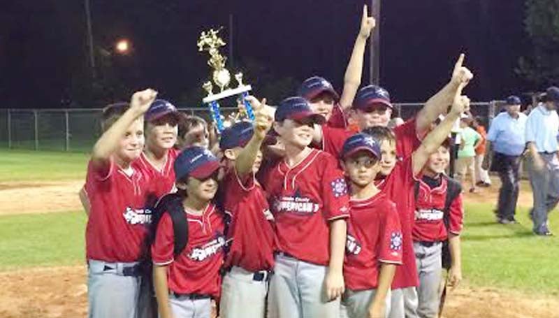 DAILY LEADER / Photo Submitted / 10-YEAR-OLD AMERICAN DISTRICT CHAMPS - The Lincoln County Americans 10-year-old All-Stars proudly hoist the AAA District Championship trophy after defeating McComb Saturday night at Keystone Park.