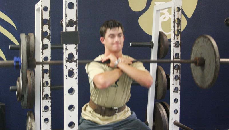 DAILY LEADER / Tucker Lambert works on his upper body strength while doing front squats during Bogue Chitto's summer workout. The Bobcats' will begin football practice Monday, August 3. The season opener will kickoff August 21 as Bogue Chitto host the Loyd Star Hornets at Troy Smith Field for their annual Possum Bowl matchup.