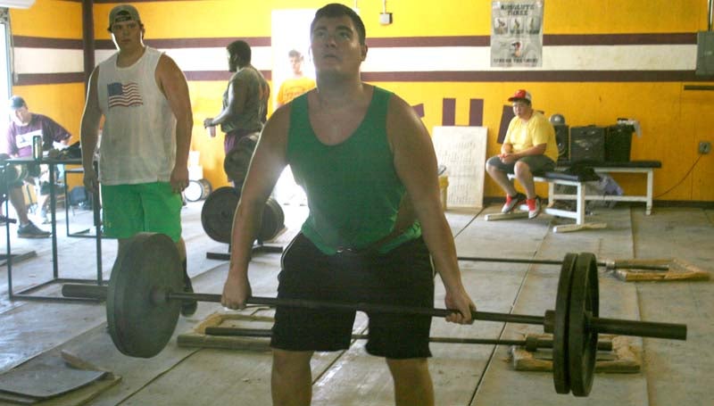 DAILY LEADER / Grayson Bennett builds up his strength on dead lift exercises during Enterprise's summer workout.