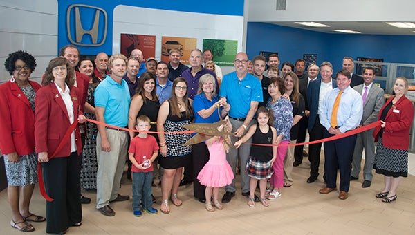 Julia V. Pendley / Employees, family, friends and Chamber members celebrate the opening of the renovated Mike Whatley Honda dealership.