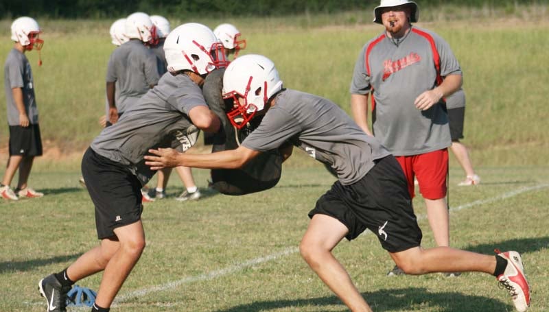 DAILY LEADER / MARTY ALBRIGHT / Loyd Star's Conner Allen (right) works on his tackling technique as teammate Braden Ezell hold onto the tackling pad Monday afternoon.