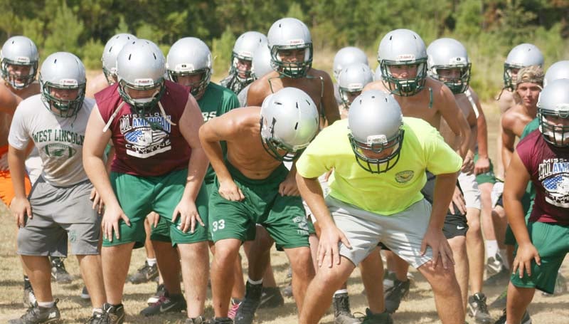 DAILY LEADER / MARTY ALBRIGHT / West Lincoln's Jayden Rushing and the rest of his teammates prepare for practice as they do some warm up drills to get ready. The Bears will host a fall scrimmage against Magee on Aug. 14 at Perry Mille Field.