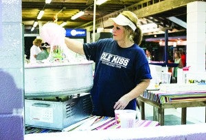 Lucy Watts swirls cotton candy at the large concession stand. 