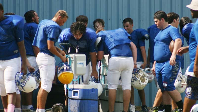 DAILY LEADER / MARTY ALBRIGHT / Wesson football players takes a break from the heat to stay hydrate.
