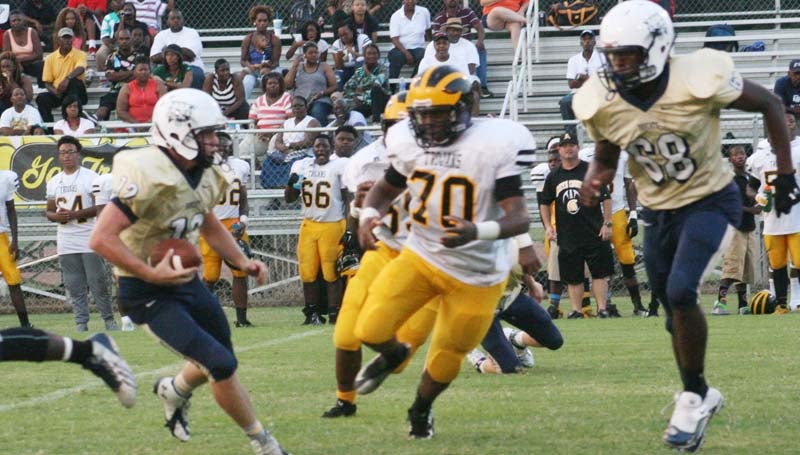 DAILY LEADER / MARTY ALBRIGHT / Bogue Chitto quarterback Connor Douglas (12) looks for some running room as teammate Brandon Blackwell (68) prepares to make a block on Amite County's defensive lineman Friday night.