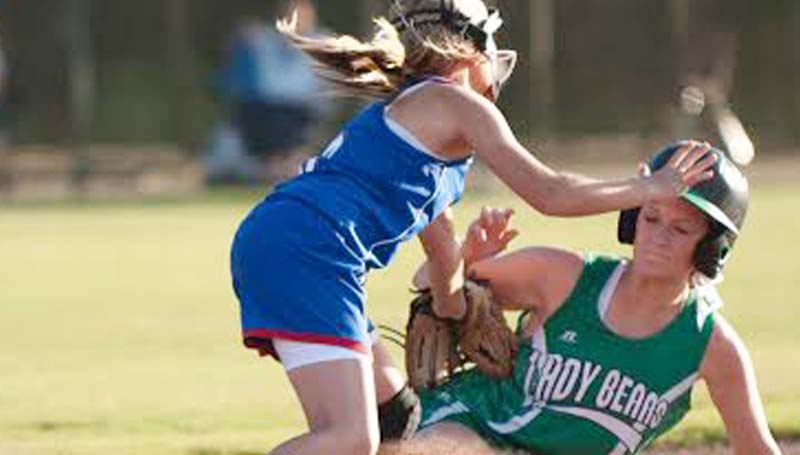DAILY LEADER / Teresa Allred / West Lincoln's Ali Mullins (right) slides into second base safely as Wesson's Brook Jones attempts to make the tag Tuesday.