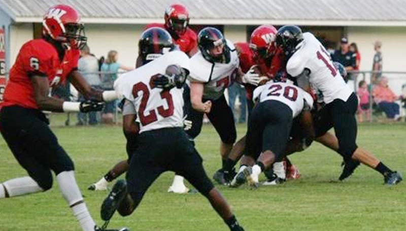 DAILY LEADER / Jana Harp / Lawrence County's defense teams up to tackle West Marion's runningback Friday night in Foxworth.