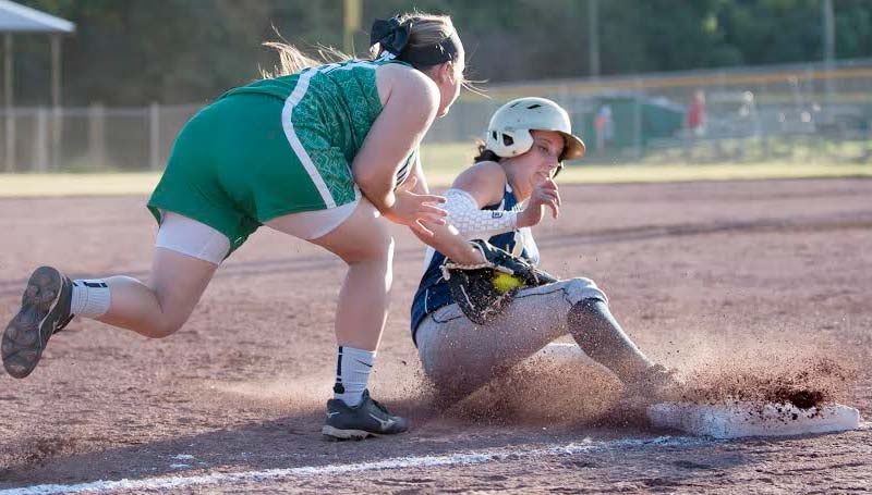 Daily Leader / Teresa Allred / West Lincoln's third baseman Anna Brooke Davis applies the tag on Franklin County's runner Shelly Case (21) as she slides in safely at third base Thursday night.