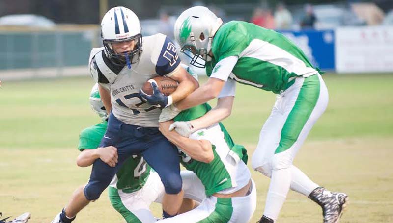 DAILY LEADER / Teresa Allred / Bogue Chitto's running back Kolby Roberts (13) tries to battle away from several West Lincoln's tacklers in Friday football action at Perry Miller Field.