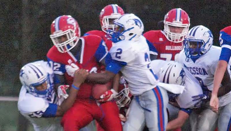 DAILY LEADER / Tracy Fischer / Wesson defenders Demarcus Smith (55) and Jeremiah Stapleton (2) work together to bring down Seminary's Felix McCullum (12) Friday night.