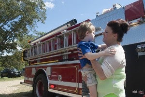 Gabe and his mother, Lindy Allbritton, celebrate his safety with pizza and a ride on the fire truck.