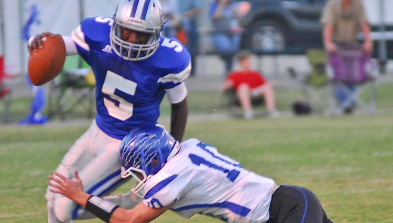 Natchez Democrat / Brookhaven Academy's defensive tackler Madison Smith (10) tries to bring down ACCS quarterback Carlos Woods (5) in the backfield Friday night in Natchez.