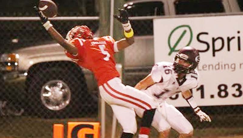 Daily Leader / Amy Rhoads / Loyd Star's James Beard (5) stretches to intercept a pass as a Stringer defender looks on Friday night.