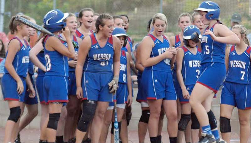 Daily Leader / Tracy Fischer / Wesson's Katie Westbrook is greeted at home plate by her teammates after hitting a home run Tuesday against Morton in Class 3A state softball playoffs.
