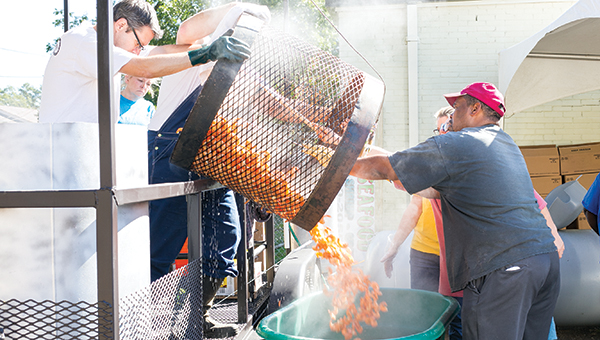 Photos by Kaitlin Mullins Junior Auxiliary members work Wednesday morning to prepare plates from the 5,000 pounds of shrimp for the annual Peel ‘Em and Eat ‘Em Shrimp Dinner at the Brookhaven Recreation Department. The event will be held from 3 to 7 p.m. today at the recreation department. The plates include boiled shrimp, baked potato salad, corn on the cob, crackers, butter and cocktail sauce. The event will also feature the Sweet Shoppe bake sale, which will include a variety of delicious homemade cakes and other sweets.