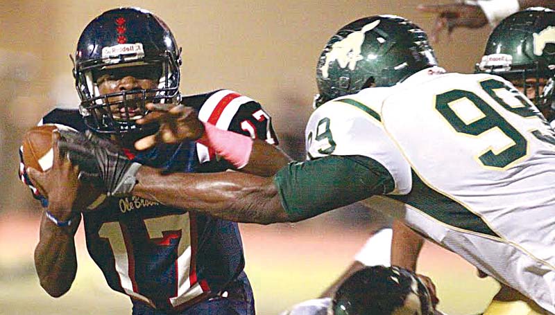 Daily Leader / Jonathon Alford / Brookhaven's freshmen quarterback Sevante Quinn (17) looks to get off a quick pass as West Jones defender Tyone Clemons (99) leaps in to record a sack Friday night at King Field.