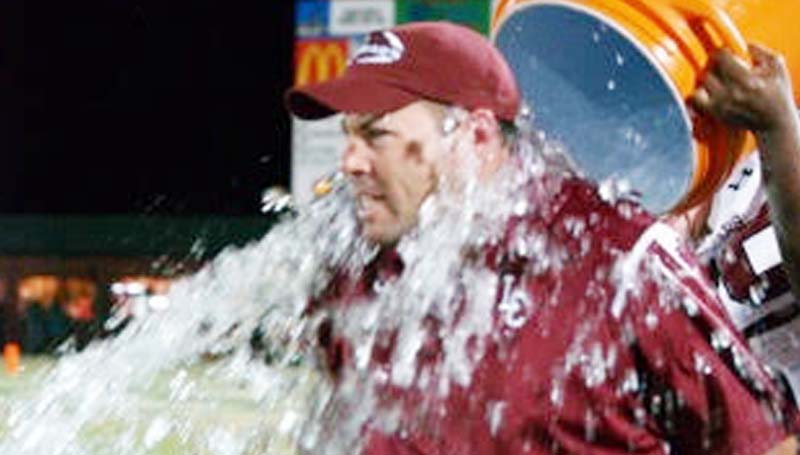 Daily Leader / Jana Harp / Lawrence County's head football Jaymie Palmer receives an ice water cooler shower Friday night after winning the Region 6-4A crown against Richland.