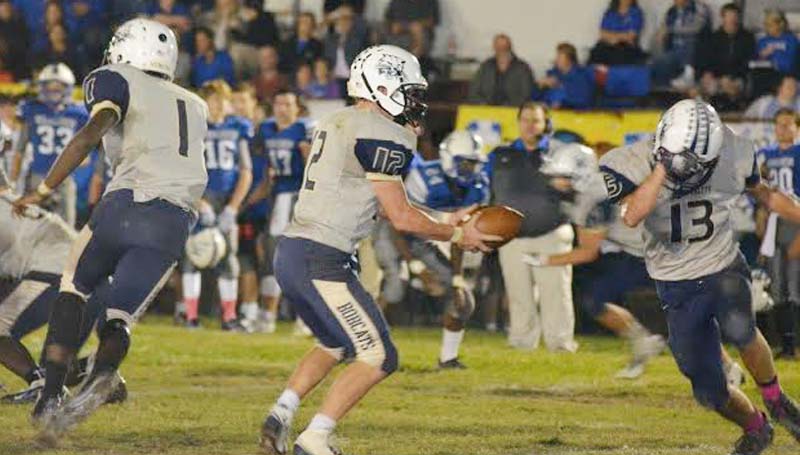 Daily Leader / Stacy Leake / Bogue Chitto's quarterback Conner Douglas (12) prepares to make a handoff to running back Kobe Roberts (13) in football action Friday night in Hattiesburg.