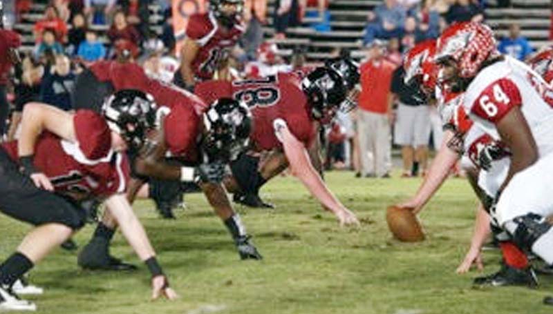 Daily Leader / Jana Harp / Lawrence County's defense lines up to make a big stop Friday night against Florence in Monticello.