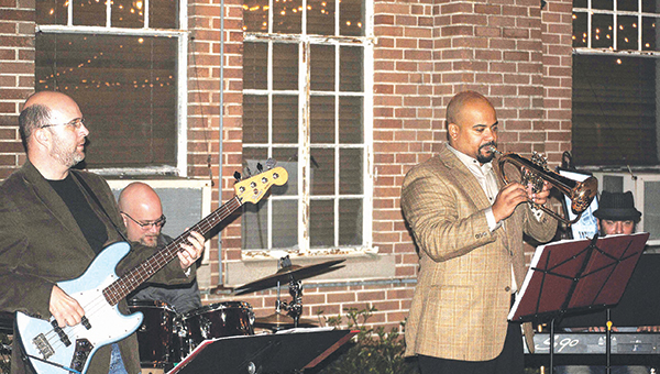 Photo by Aaron Paden Tyler Bridges, Nick Bridges, Damian Gatlin, and Marvin Curtis jam out at the Taste of Trust fundraiser Thursday night.