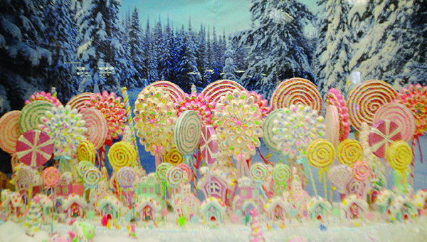 Photo by Aaron Paden / A giant snow globe containing a miniature village surrounded by a forest of candy canes sits in the Lincoln County Public Library.