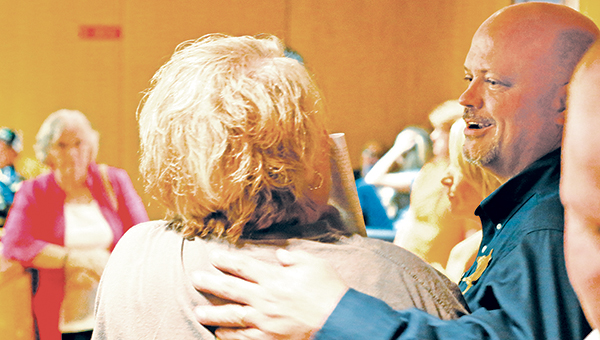 Photo by Kaitlin Mullins Steve Rushing (R) talks with a supporter Tuesday night after election results showed he has been re-elected to serve a third term as Lincoln County sheriff.